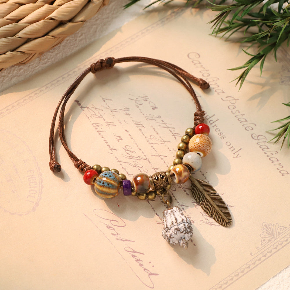 Woven bohemian bracelet with white feather charm detail | DIY Jade
