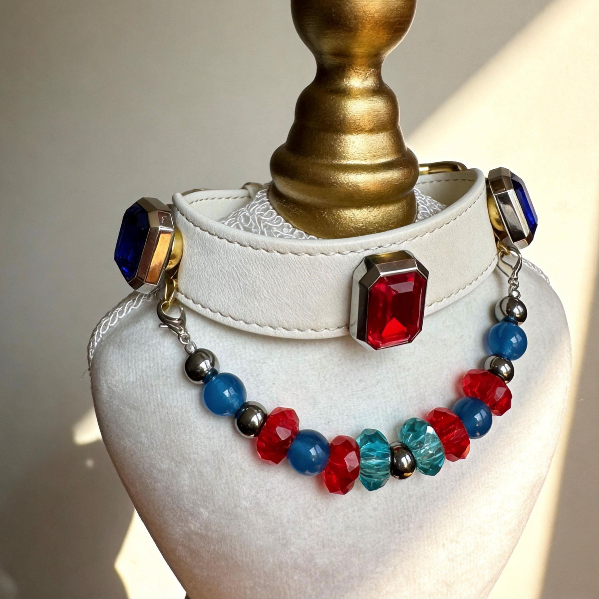 Mannequin bust showing cream pet collar with red gem and vibrant mixed blue red jade beads | DIY Jade