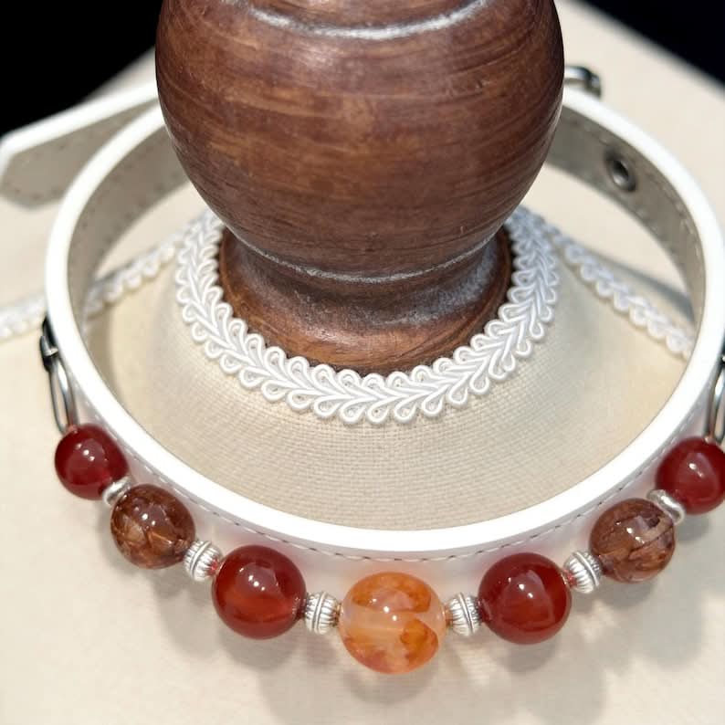 White faux‑leather pet collar with red and orange agate beads on display bust | DIY Jade