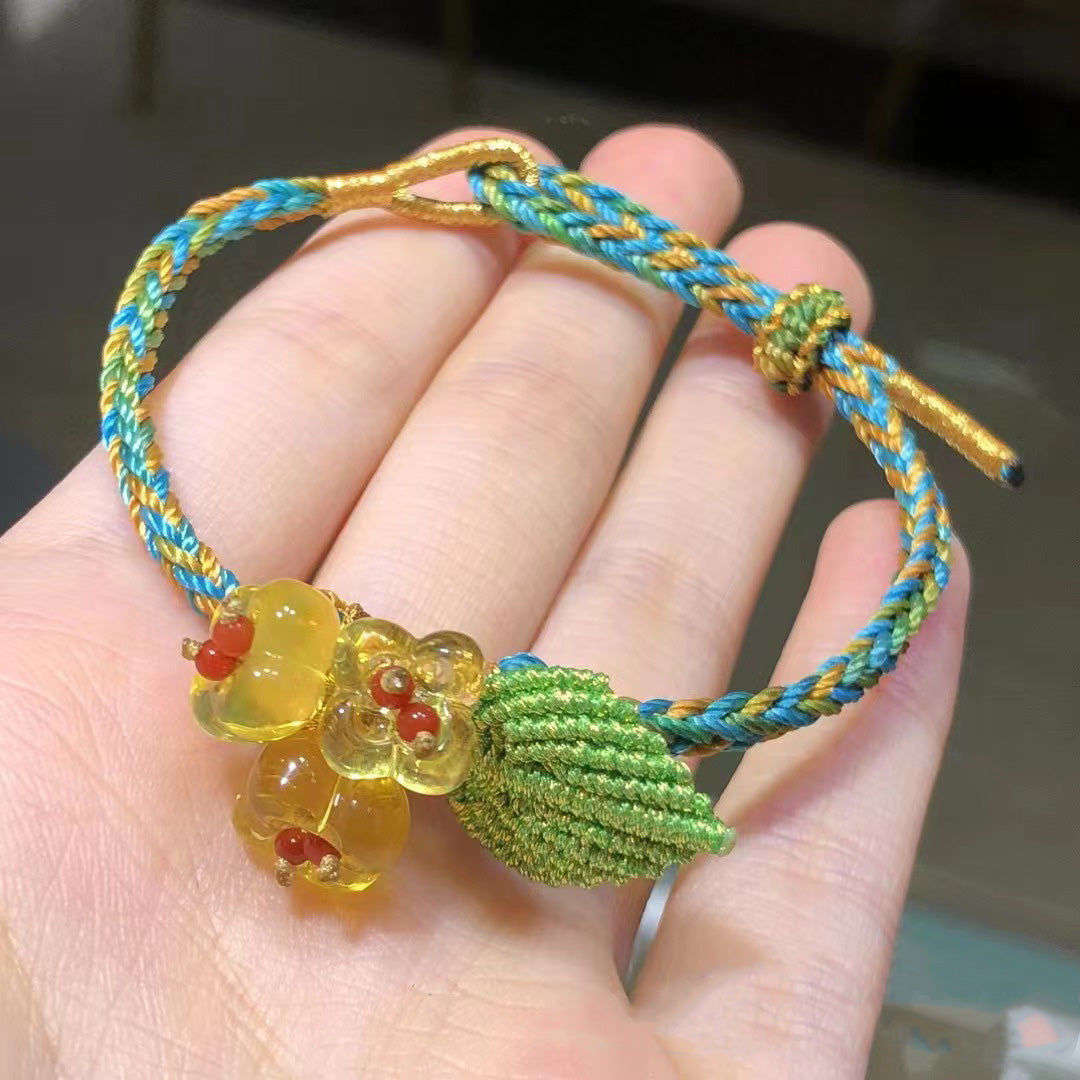 Braided cord bracelet with amber flower charm and green leaf | DIY Jade