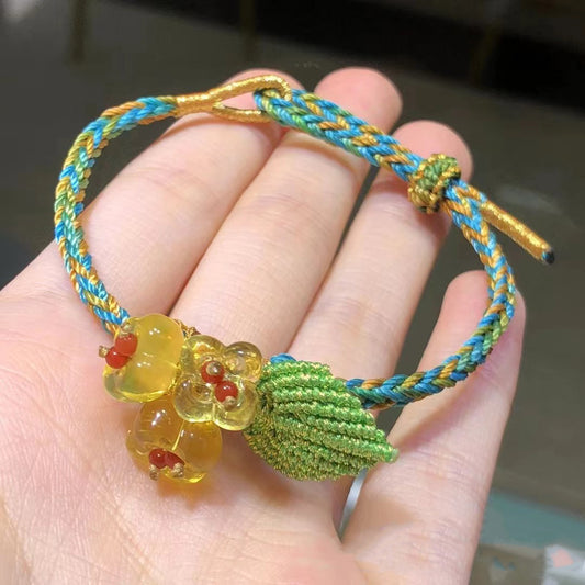 Braided cord bracelet with amber flower charm and green leaf | DIY Jade