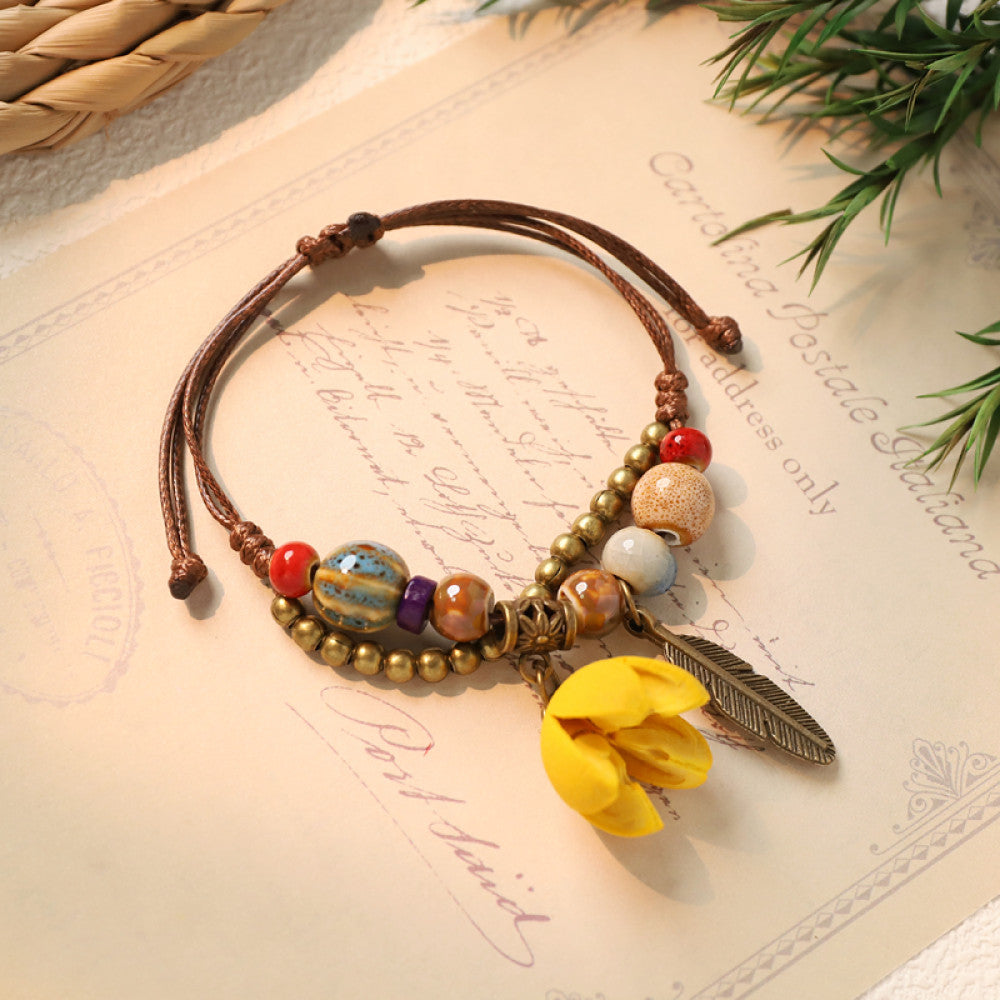 Ethnic bracelet with yellow flower charm and feather detail | DIY Jade