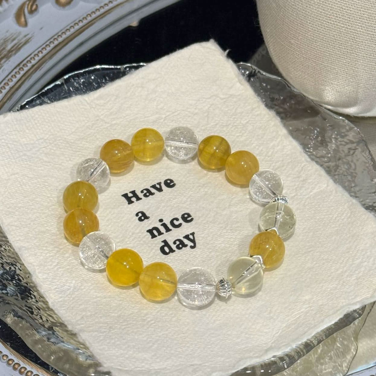 Yellow fluorite and white agate crystal bracelet flat lay on round card showing bead arrangement | DIYJade