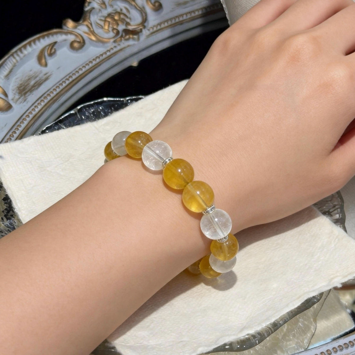Yellow fluorite and white agate crystal bracelet worn on owner's wrist, close-up | DIYJade