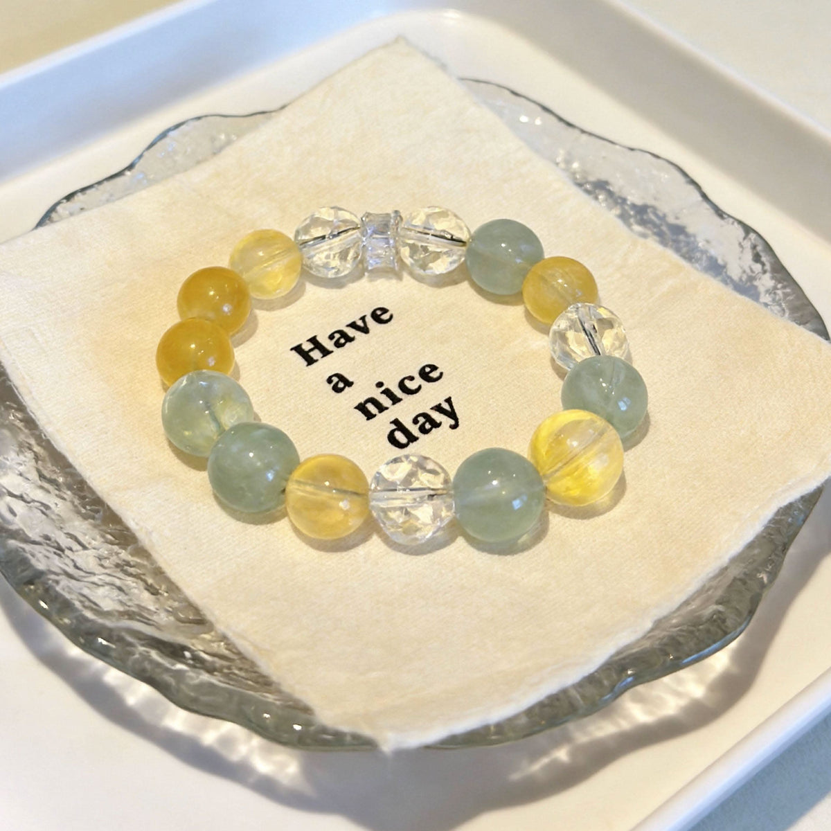 Yellow green bead lace pet collar flat lay shot on cream textured paper | DIY Jade